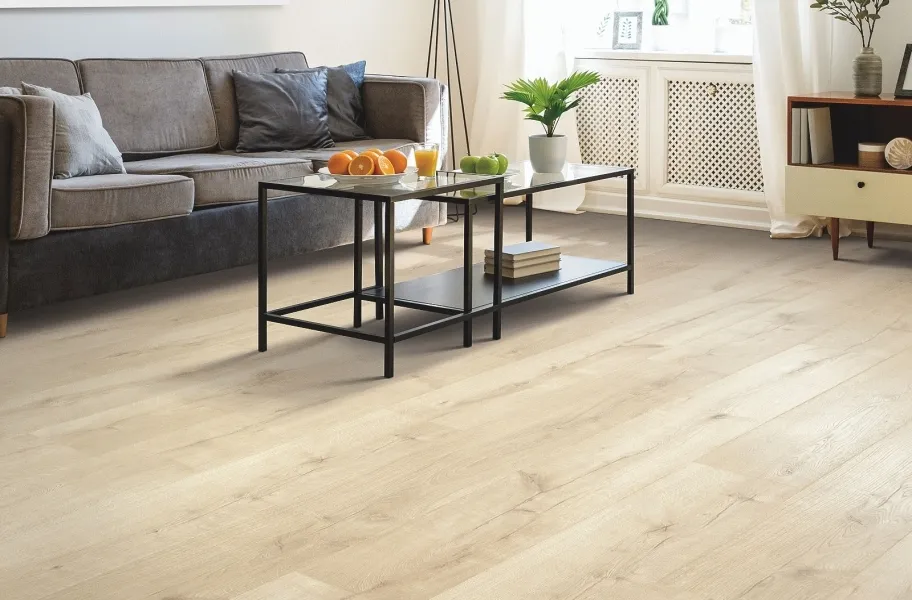 Modern living room with light oak vinyl flooring, dark sofa, and minimalist coffee table.