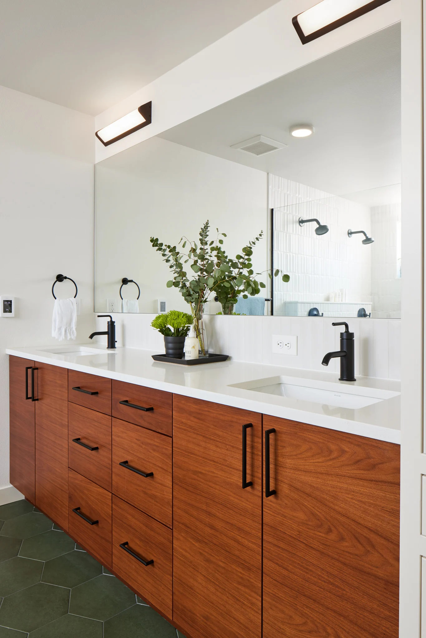 Modern double vanity with wood cabinets and black fixtures