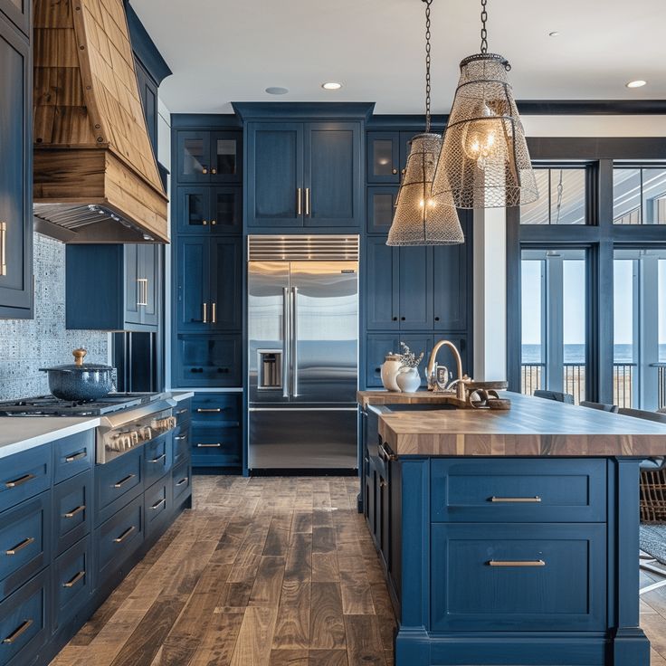 Navy blue kitchen with wood countertops, stainless steel appliances, and ocean view