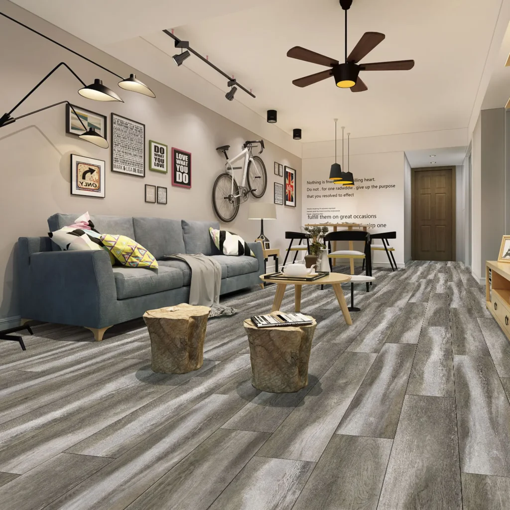 Modern living room with gray wood-look vinyl flooring, blue sofa, wall art, and ceiling fan.