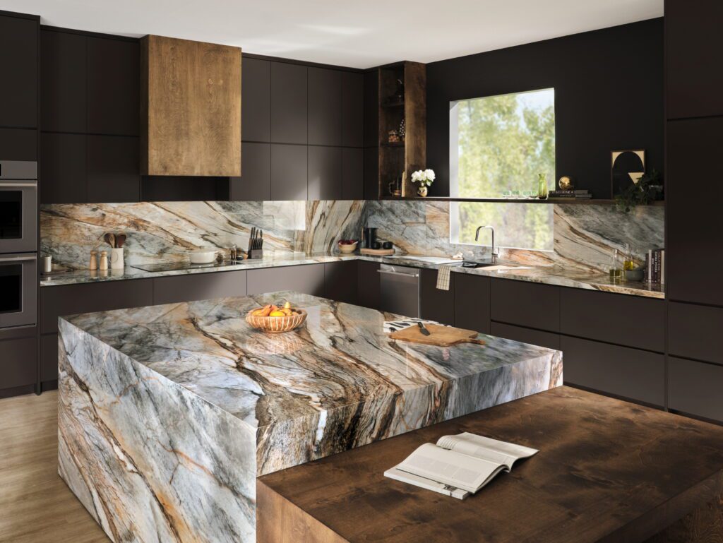 Modern kitchen featuring striking veined natural stone countertops and backsplash with dark cabinetry and wood accents