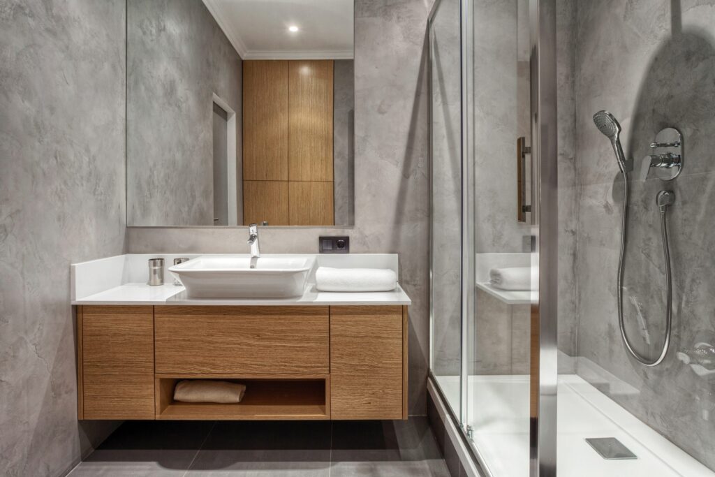 Minimalist bathroom with floating wood vanity and glass shower