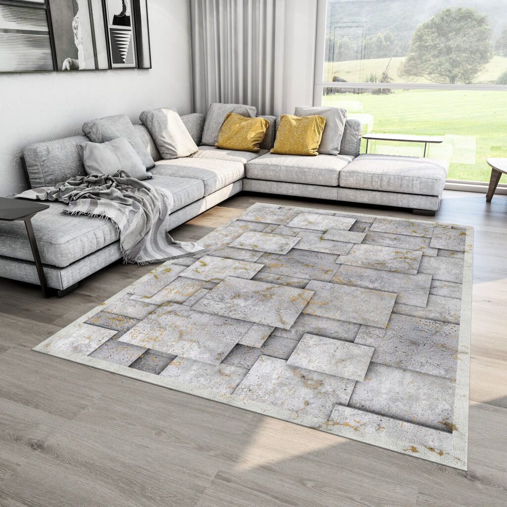 Modern living room with light gray sectional sofa, wood flooring, and a stone-pattern area rug.