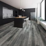Modern kitchen with dark wood-look vinyl flooring, black cabinets, and a central island with bar stools.
