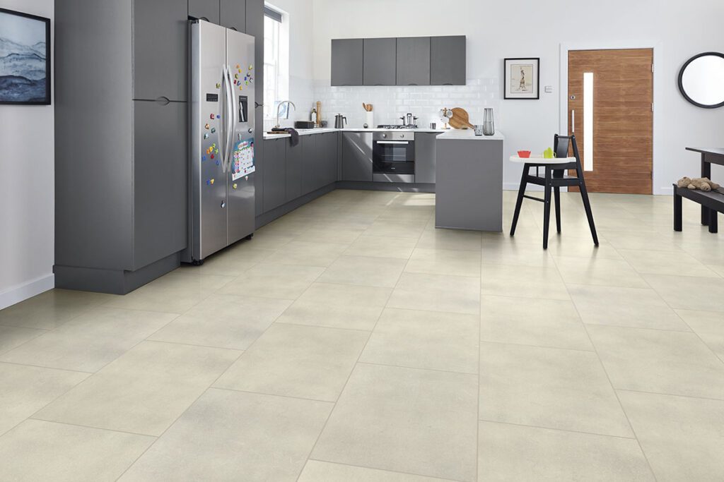 Modern kitchen with light stone-look tile flooring, gray cabinets, and stainless steel appliances.