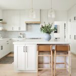 Modern white kitchen with shaker cabinets and island seating